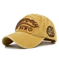 Close-up of vintage mustard yellow baseball cap with 3D embroidery and side compass patch - Yellow
