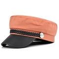 Detail view of pink cotton newsboy cap with black leather brim and silver crest button - M / Orange
