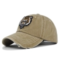 Detailed view of vintage washed baseball cap with 3D tiger embroidery and distressed brim - Khaki