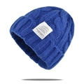 Detailed view of cable-knit electric blue beanie texture with white fabric label - One Size / Blue
