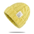 Close-up of yellow chunky knit beanie featuring twisted cable pattern and a white woven label - One Size / Yellow