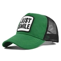 Detail of the embroidered Just Smile patch on the green mesh trucker baseball cap - Adjustable / Green & Black