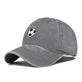 Detailed close-up of distressed charcoal grey baseball cap with embroidered soccer ball - Gray