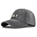 Detail shot of vintage washed denim fabric and 3D embroidered EAT lettering on baseball cap - Gray