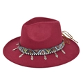 Dettaglio di cappello in lana bordeaux con fascia etnica e ciondolo a cuore in argento - Borgogna