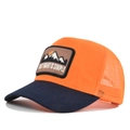 Close-up of orange mesh trucker hat with mountain embroidery and blue brim - Adjustable / Navy Blue Splice Orange