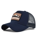 Detailed close-up of navy blue trucker hat featuring mountain embroidery and mesh back - Adjustable / Navy Blue