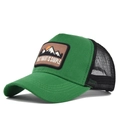Close-up of a green trucker hat with breathable mesh and mountain embroidery patch - Adjustable / Green