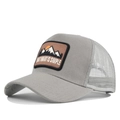 Detailed side view of grey trucker hat with mountain embroidery and mesh back panel - Adjustable / Light Gray