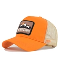 Detail view of orange trucker hat featuring mountain embroidery and beige mesh panels - Adjustable / Orange