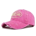 Detail shot of pink washed cotton baseball cap with New Orleans embroidery and distressed brim - Adjustable / Rose Red