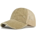 Detailed macro view of khaki distressed mesh trucker hat with worn-out holes and vintage texture - Khaki