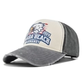 Detailed macro view of vintage eagle embroidery and distressed edges on baseball cap - Gray