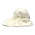 Detail view of beige wide brim sun hat showing unique pleated fabric and canvas texture - M (56-58cm) / Cream