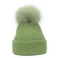 Close-up of light green knitted beanie with thick ribbing and large fluffy pompom top - M / Green