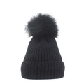 Detailed close-up of a black ribbed knit beanie featuring a large faux fur pom-pom detail - M (56-58cm) / Black