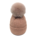 Close-up of ribbed knit texture and large fluffy faux fur pompom on winter beanie - M / Pink
