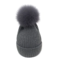 Detail of dark grey rib-knit winter beanie featuring a large fluffy faux fur pom-pom - M / Dark Gray