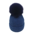 Detailed knit texture of dark blue winter beanie with large fluffy pom-pom on white background - M / Dark Blue