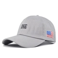 Close-up of grey cotton baseball cap featuring USA embroidery and American flag patch - Gray
