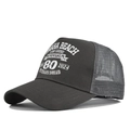 Close-up of dark grey trucker cap featuring white screen-printed Normandy veteran graphics - Dark Gray