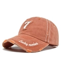 Detailed close-up of vintage washed red baseball cap with distressed brim and 7 embroidery - Adjustable / Orange