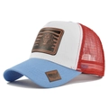 Detail of truck cap showing leather lion patch and red mesh back on blue-white panel - Blue + White