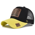 Detail of lion leather patch and yellow brim on breathable black mesh trucker cap - Yellow + Black