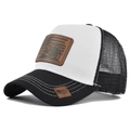 Detail view of truck hat featuring tractor leather patch and white reinforced stitching - Black & White