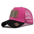 Detail of breathable mesh and brown leather patch on a two-tone pink and black trucker hat - Black with Rose Red