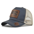 Close-up of trucker hat with cow leather patch and american flag map embroidery details - Adjustable