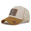 Close-up of mesh trucker hat featuring embossed leather patch and classic curved brim - Khaki and Beige