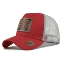 Detailed close-up of a red trucker hat featuring a leather lion patch and mesh back - Red