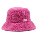 Detail of soft dark pink teddy fleece fabric and woven brand label on the bucket hat - One Size / Rose Red