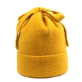 Detailed knit texture of ginger yellow winter beanie featuring a top bow decoration - M (56-58cm) / Yellow
