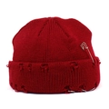 Distressed dark red knit beanie featuring stylish holes, a silver pin, and metal rings - Red