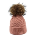 Detail of dusty pink knit beanie with ribbed texture and fluffy raccoon fur pom pom - One Size / Pink