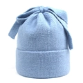 Macro shot of light blue knit beanie showing ribbed texture and large bow detail - M (56-58cm) / Blue