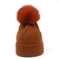 Winter knit beanie for women in dark brown featuring a fluffy orange fox fur pompom - One Size / Caramel color