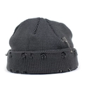 Detail of grey distressed knit beanie featuring silver safety pin and metal ring accents - Gray