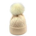 Detail of beige knit beanie with large fluffy faux fur pompom and ribbed cuff texture - One Size / Off White