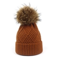 Detail showing caramel knitted beanie with diamond texture and large fluffy pompom - One Size / Caramel color