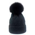 Close-up of black knit beanie with a fluffy faux fur pompom and diamond weave pattern - One Size / Black