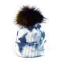 Detailed close-up of blue tie-dye knit beanie with colorful fluffy pom-pom and ribbed texture - One Size / Blue