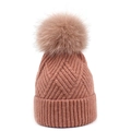 Winter knitted beanie for women featuring a large fluffy faux fur pom-pom in dusty pink - One Size / Pink