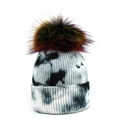 Black and white tie-dye knitted beanie featuring a large colorful faux fur pom pom - One Size / Black
