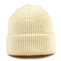 Detailed view of the thick cream knit texture and folded rim on a ribbed beanie hat - One Size / Beige