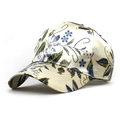 Detailed view of the elegant floral print and silk texture on the stylish baseball cap - Beige