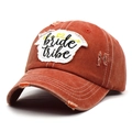 Detail of vintage washed brick red baseball cap featuring bride tribe embroidery and distressed holes - Adjustable / Orange