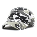 Macro detail of camouflage printed cotton twill fabric on a curved brim baseball cap - White